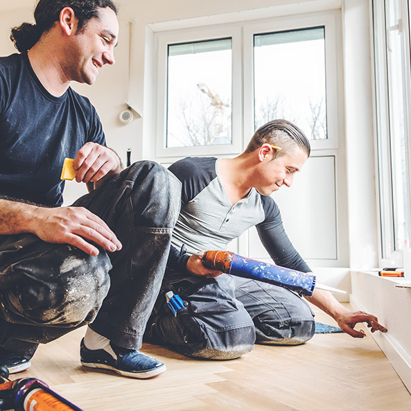 Contractors working on a baseboard